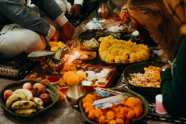 flowers and pooja materials on the floor to show tihar pooja